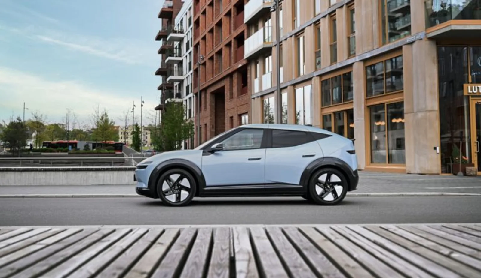 Hyundai IONIQ 3 zijaanzicht langs een modern gebouw
